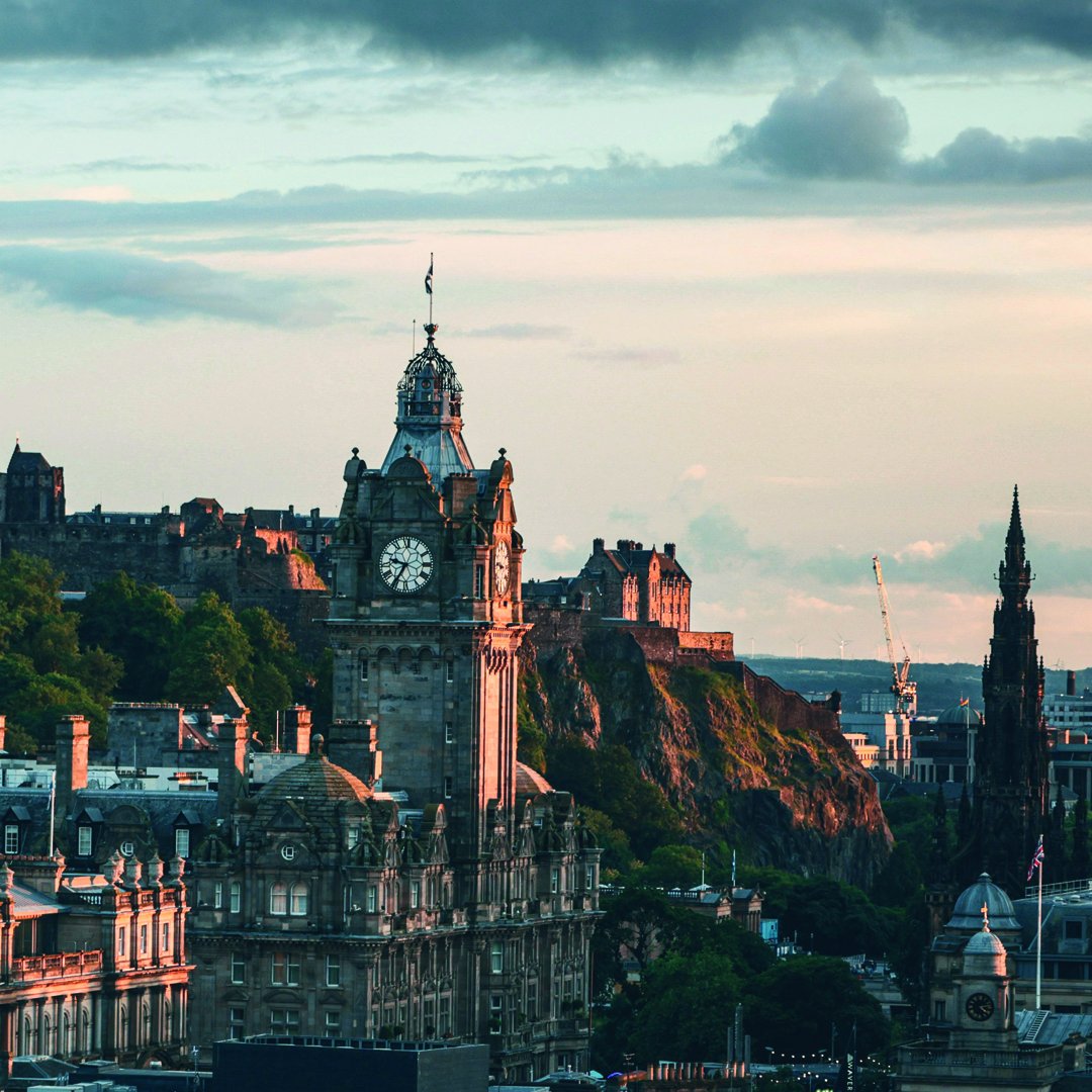 A cityscape of Edinburgh at sunset, featuring the Balmoral Hotel clock tower in the foreground and Edinburgh Castle in the background—perfect for those seeking inspiration before searching for the best student accommodation in London.