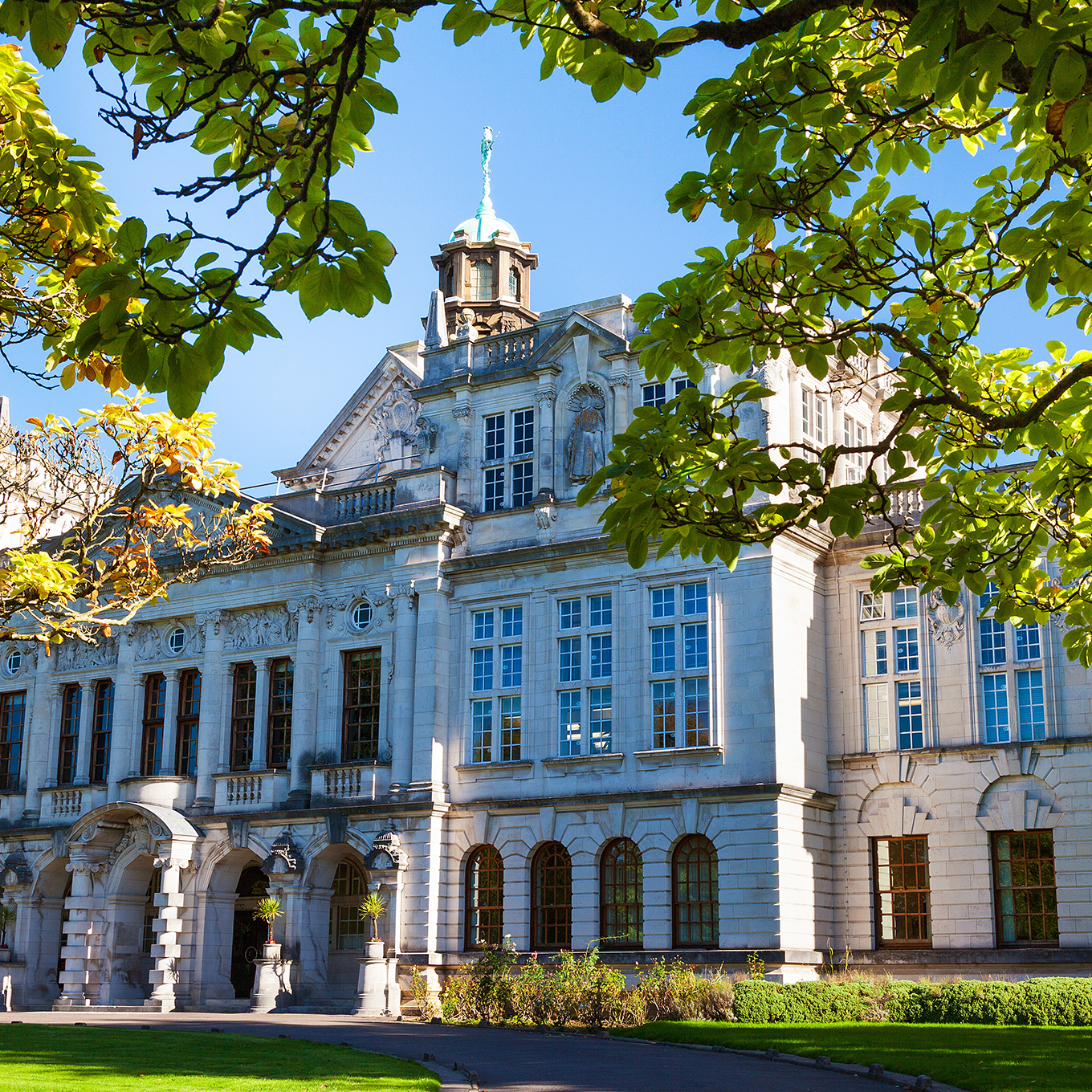 A large building in the middle of a grassy field.