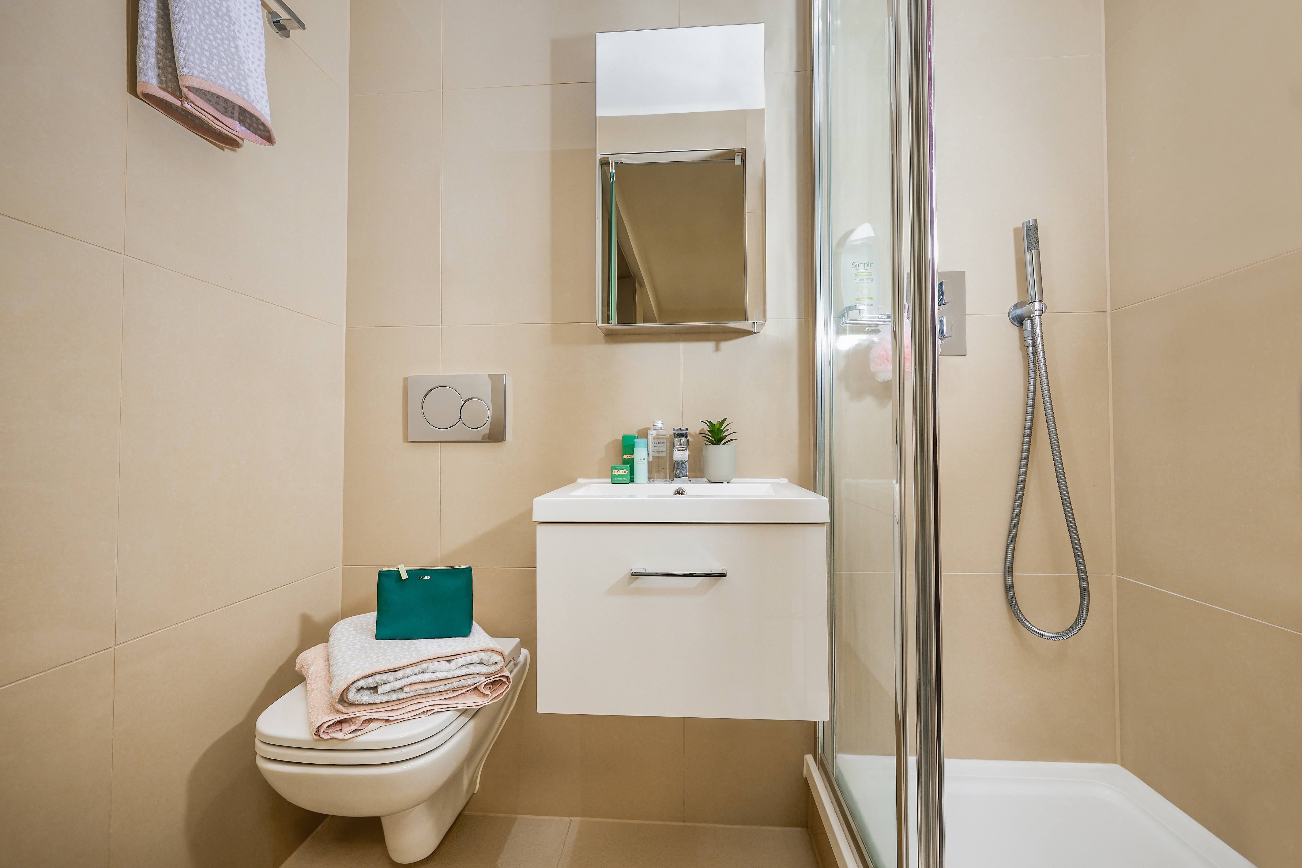 A serene bathroom in the Telephone House features a modern shower and sleek sink, creating an inviting oasis.