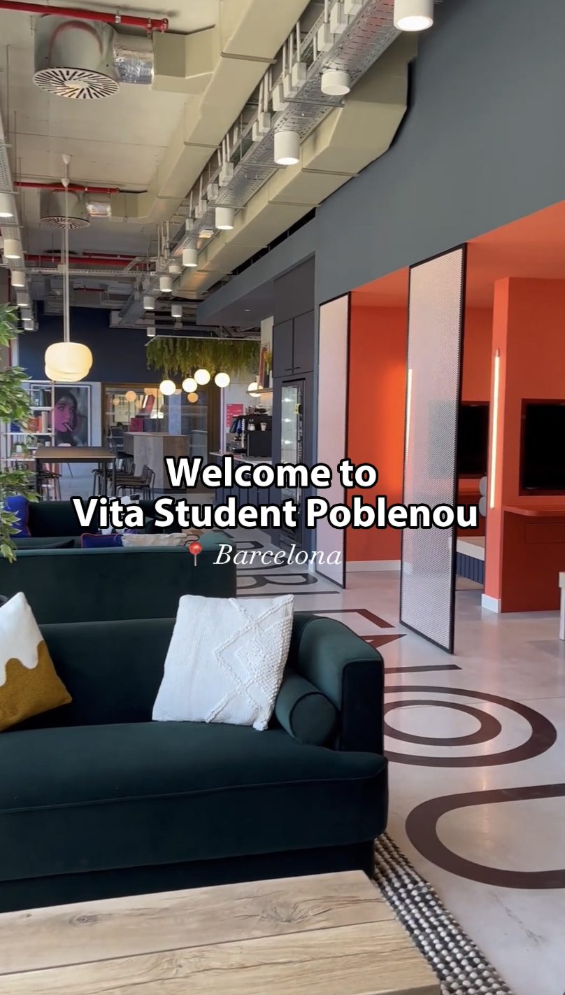 Modern lounge area in a student accommodation with green couches, pillows, circular patterns on the floor, and warm lighting. The text reads, "Welcome to Vita Student Poblenou, Barcelona.