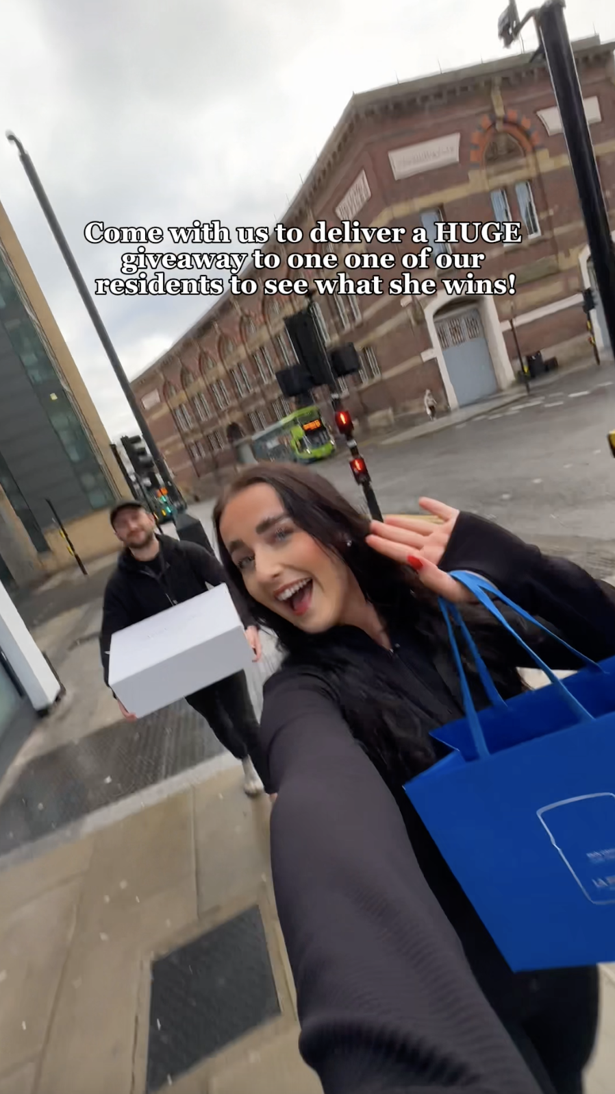 Woman and man holding competition prizes looking excited