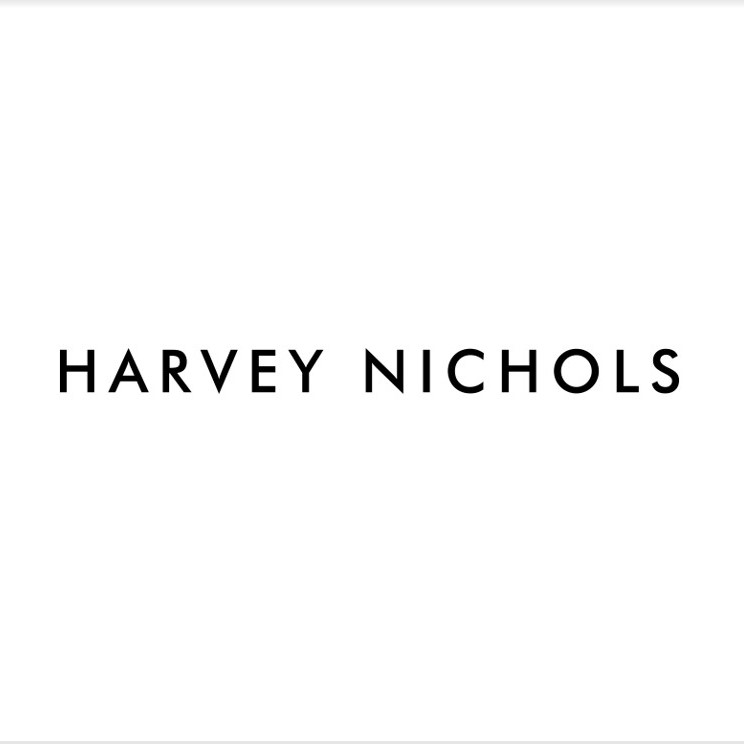 The image displays the bold black font of "Harvey Nichols" on a plain white background, embodying the sleek sophistication synonymous with top-tier brand partners like Vita Student.