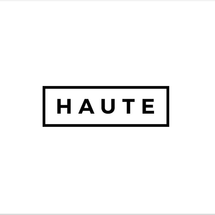 The image prominently features the word "HAUTE" in bold, uppercase black letters, elegantly framed by a thin black rectangular border on a pristine white background, reflecting the sleek aesthetics of Vita Student's brand partners.