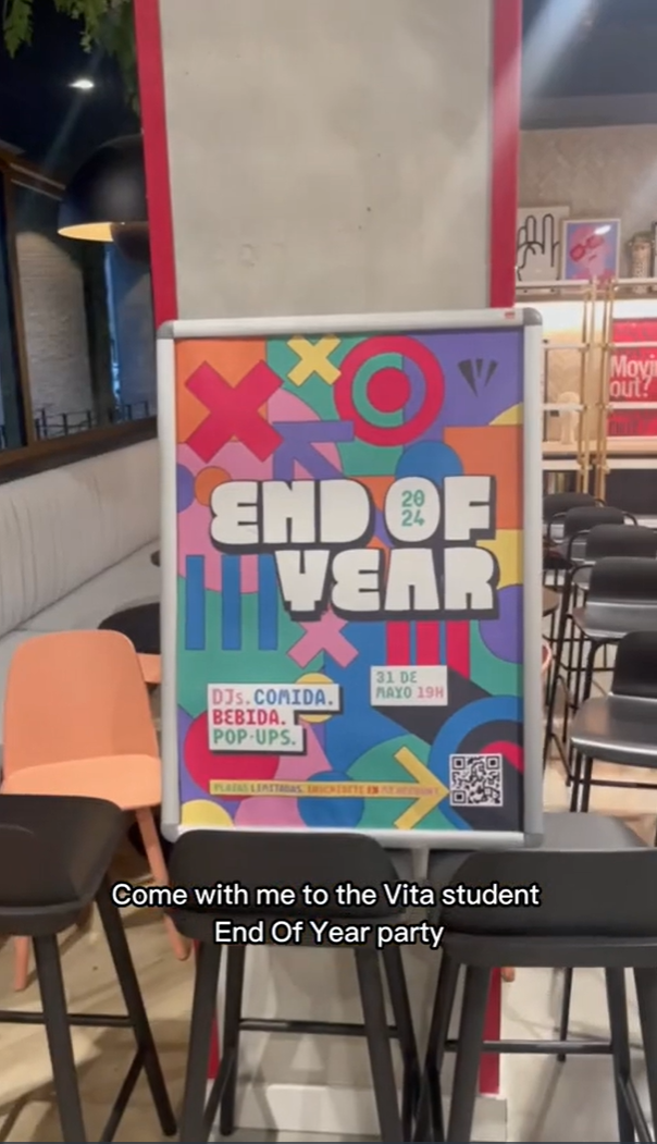 A colorful sign inside a room reads "End of Year" with the event date and details below. Chairs and tables are arranged nearby. The poster includes bright geometric shapes and text about DJs, food, drinks, and pop-ups.