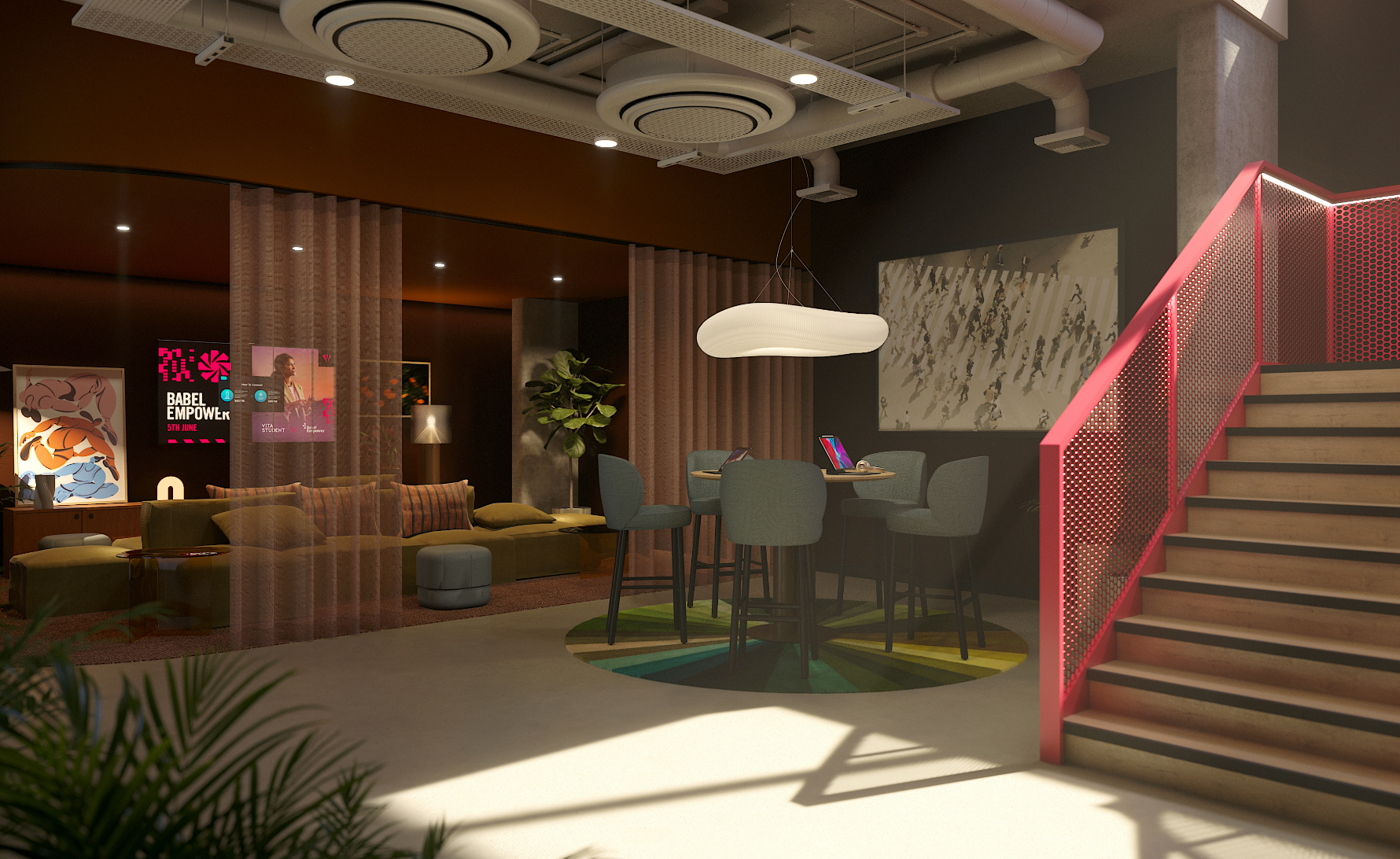 A modern lounge area features colorful posters, cozy seating with pillows, a high table with chairs on a round rug, and a staircase with a red railing. Ceiling lights and exposed pipes give the space an industrial feel.