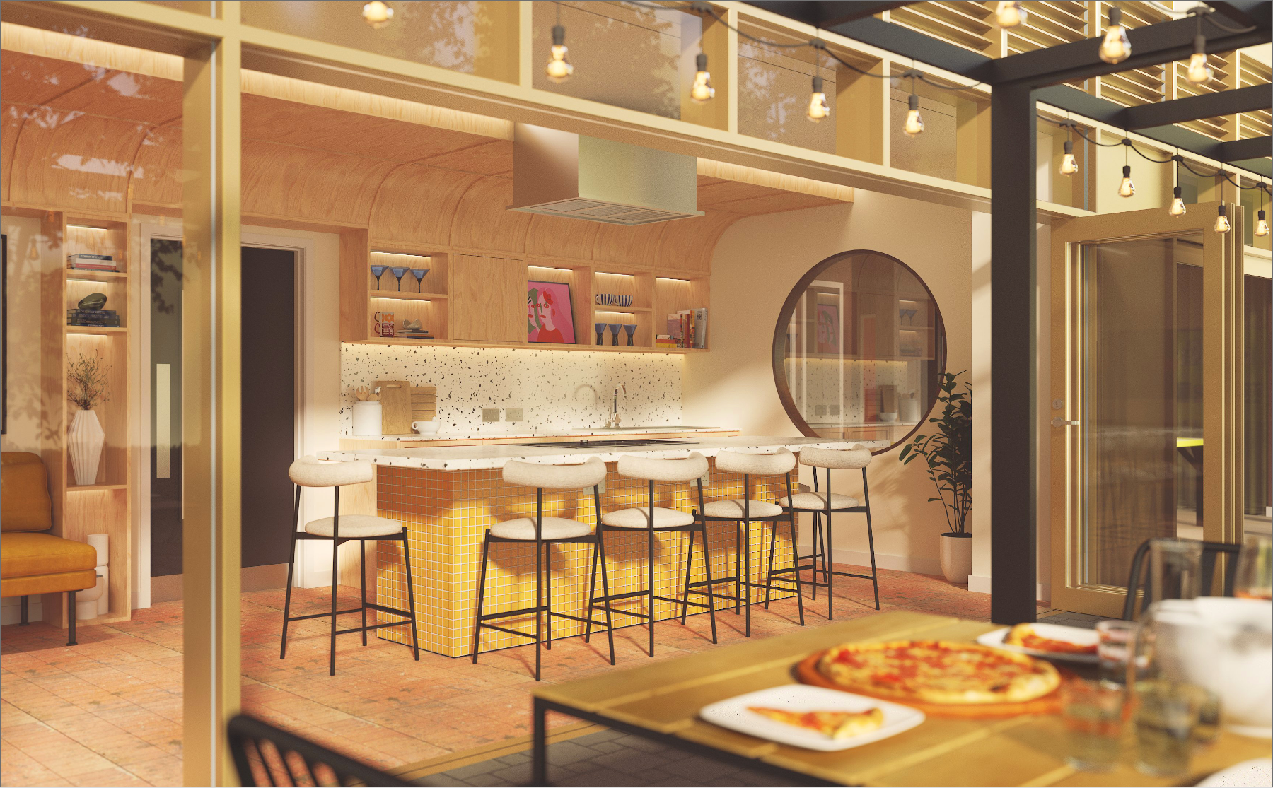 Modern kitchen with a yellow-tiled island, white bar stools, and open shelving, viewed through glass doors. String lights hang above a wooden table set with pizza and drinks in the foreground. Warm, inviting ambiance.