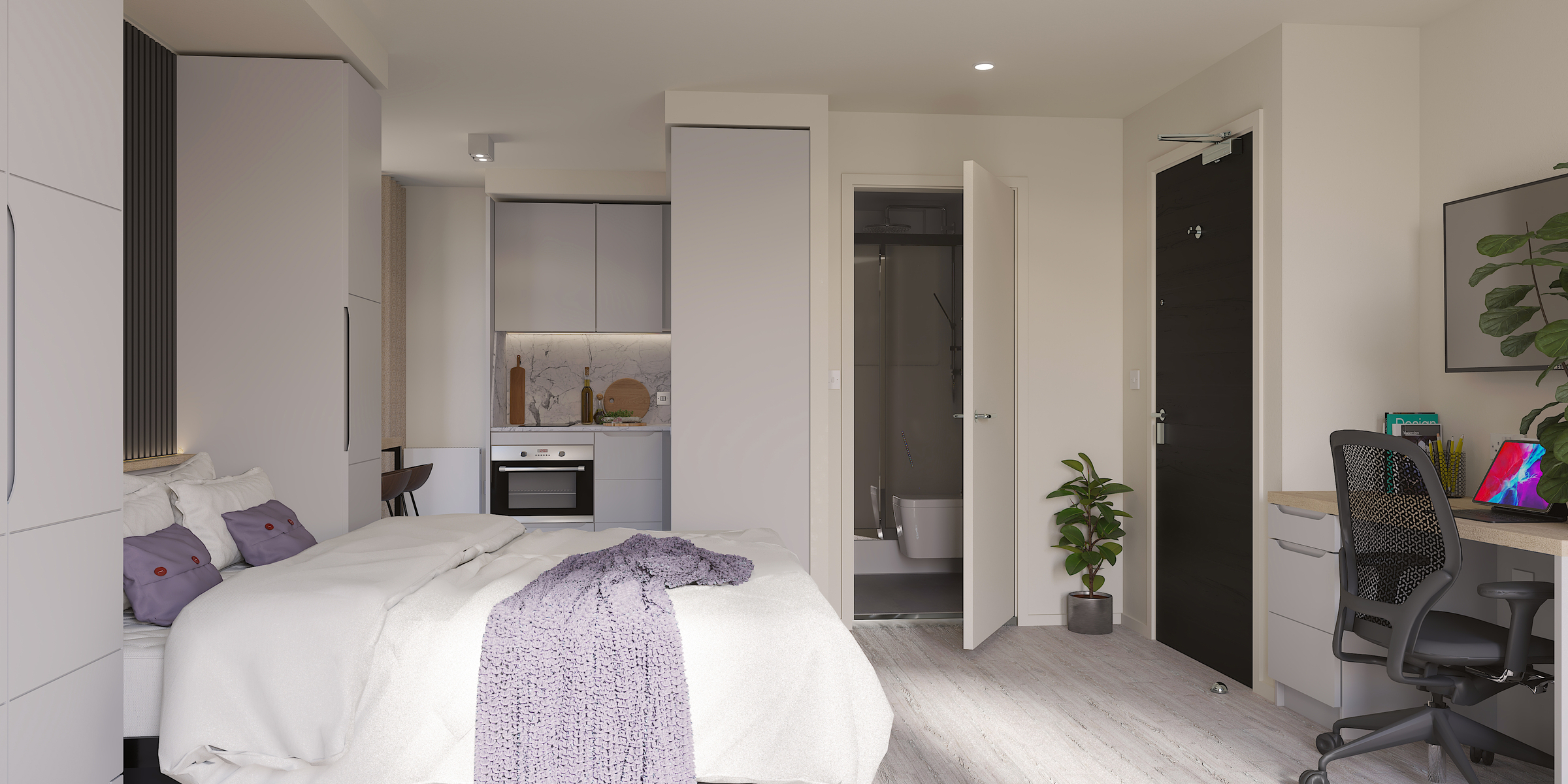 A modern studio apartment on Gough Street with a bed, a kitchen area, a desk and chair, a bathroom with an open door, and a small plant near the entrance. The room is decorated in soft, neutral colors.