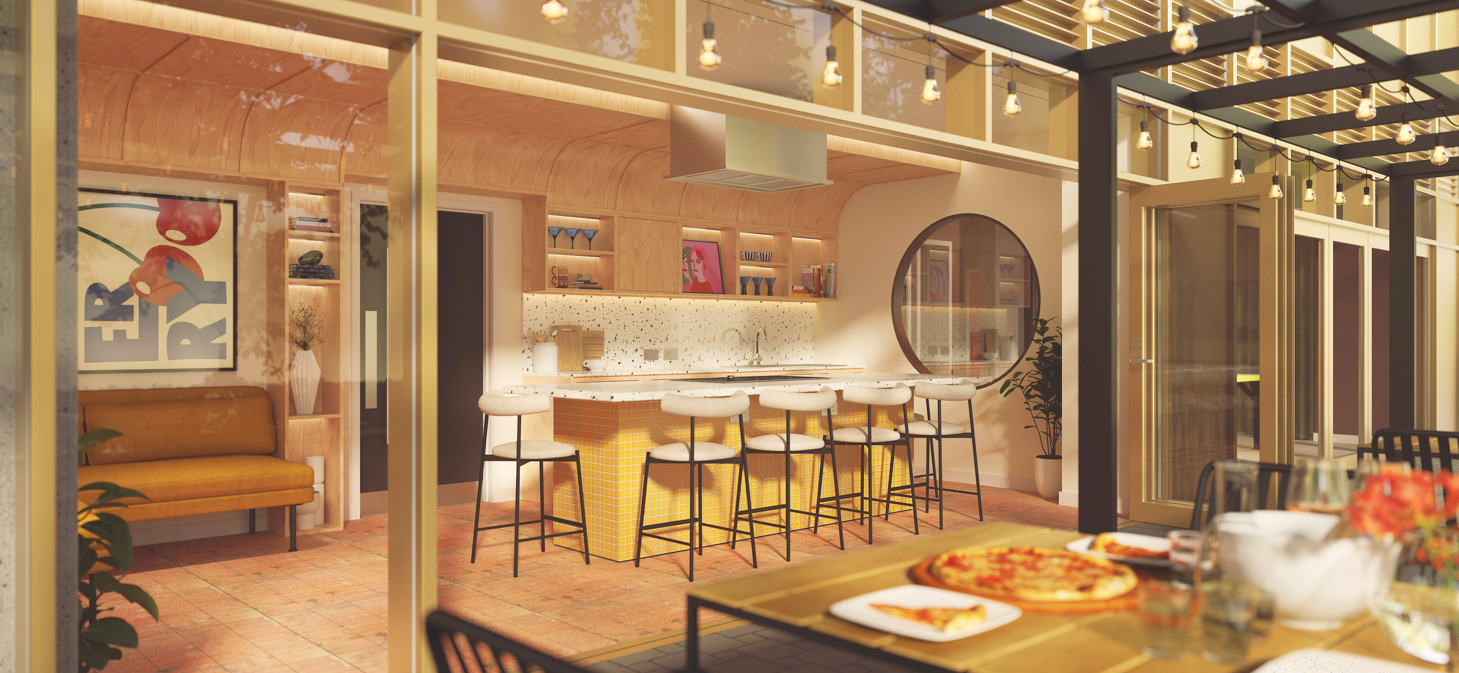 Modern indoor-outdoor dining area with a counter bar, stools, a wooden dining table set with pizza, string lights overhead, and large glass doors opening to a cozy, warmly lit kitchen space.