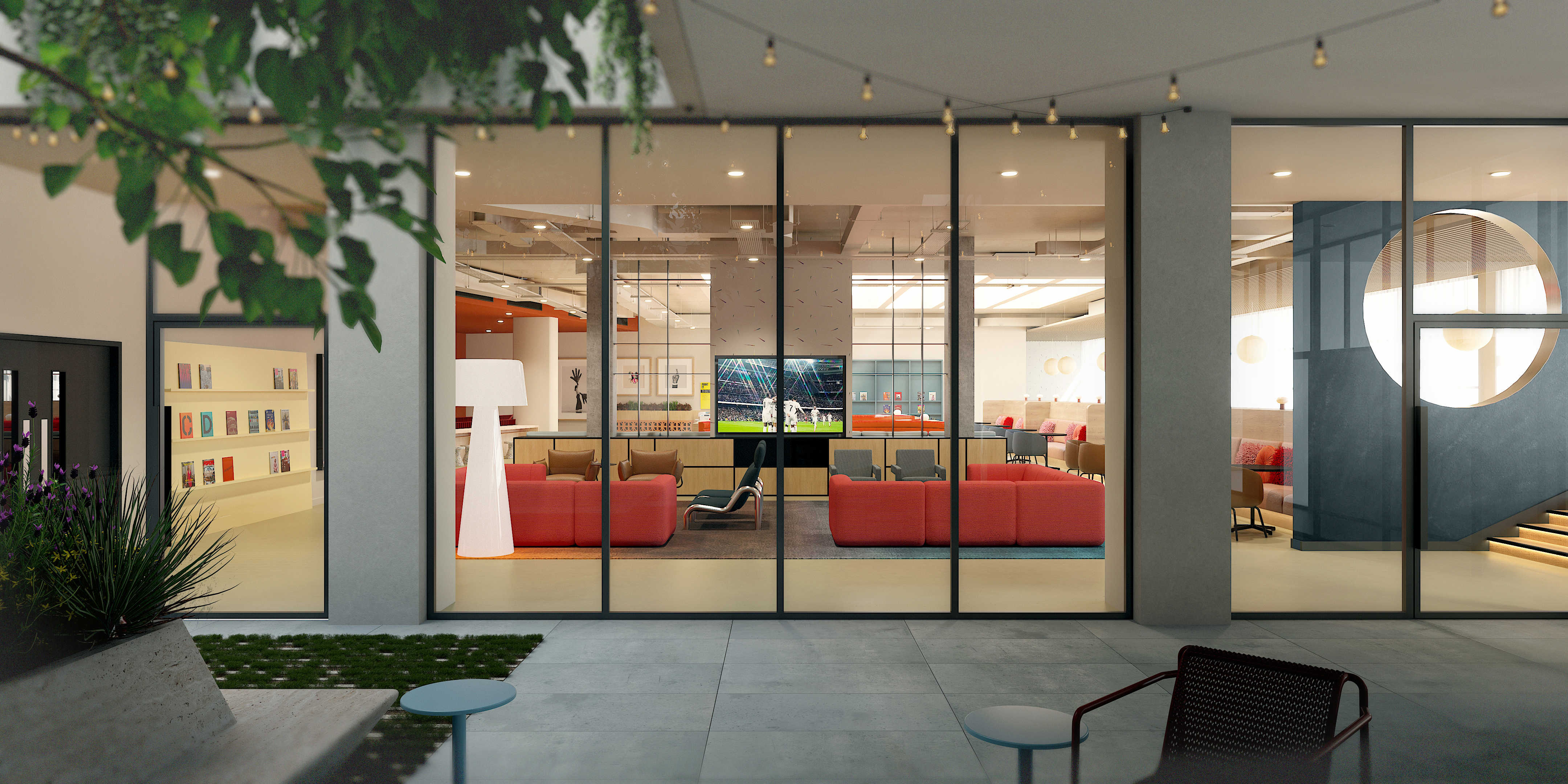 A modern lounge seen through large glass windows, featuring red and beige sofas, a central TV displaying a sports game, bookshelves, indoor plants, and a staircase with a round window. String lights hang outside.