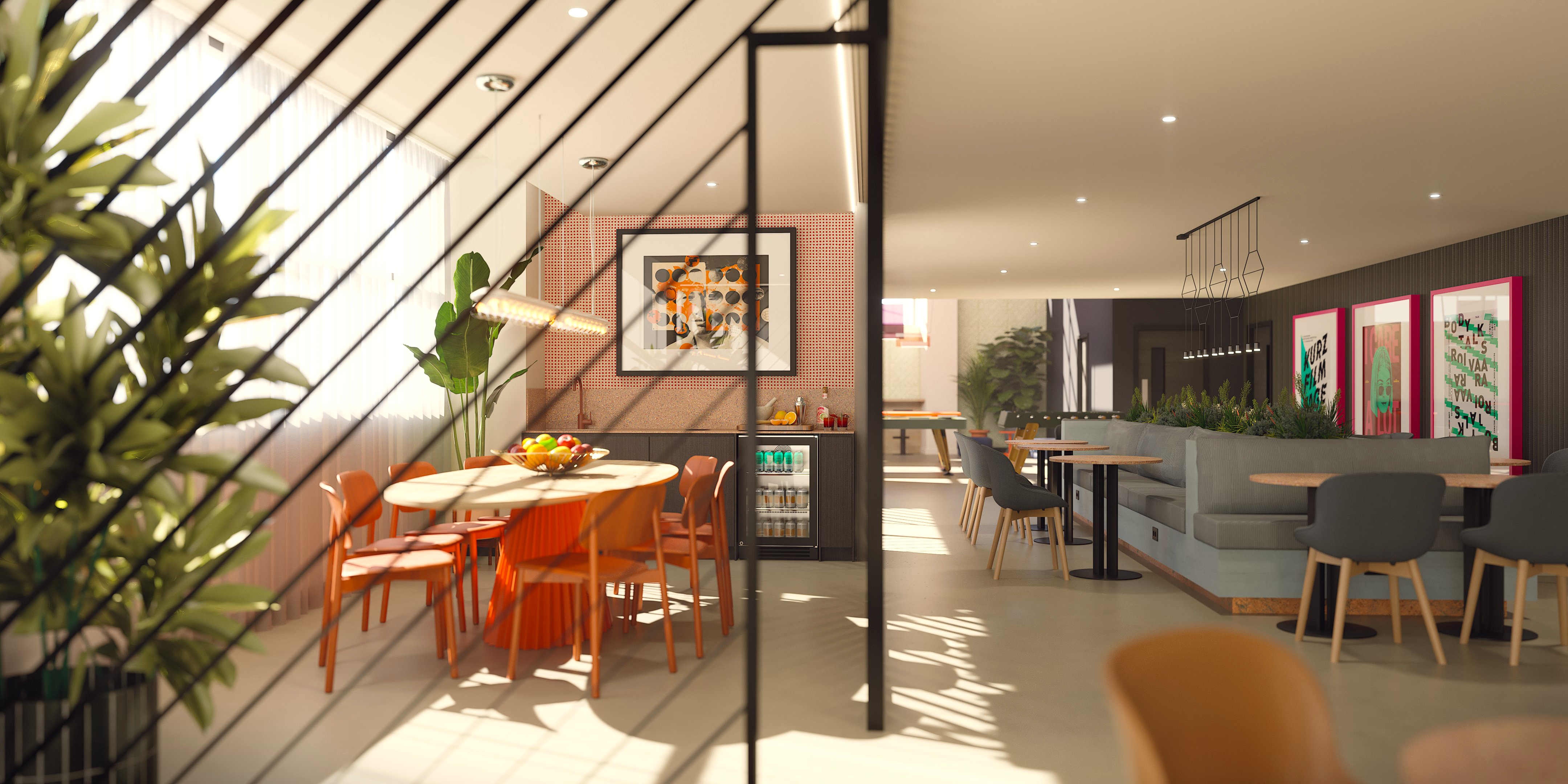 A modern, sunlit dining area with wooden tables, orange and gray chairs, plants, and framed art on the walls. Large windows let in natural light, creating a warm, inviting atmosphere.