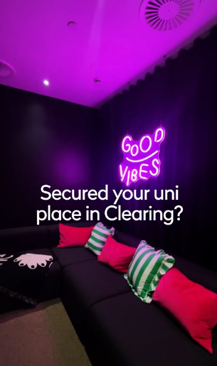 A cozy lounge with a black sofa, colorful striped and pink cushions, and a neon “Good Vibes” sign on the dark wall. Text overlay reads: “Secured your uni place in Clearing?”.