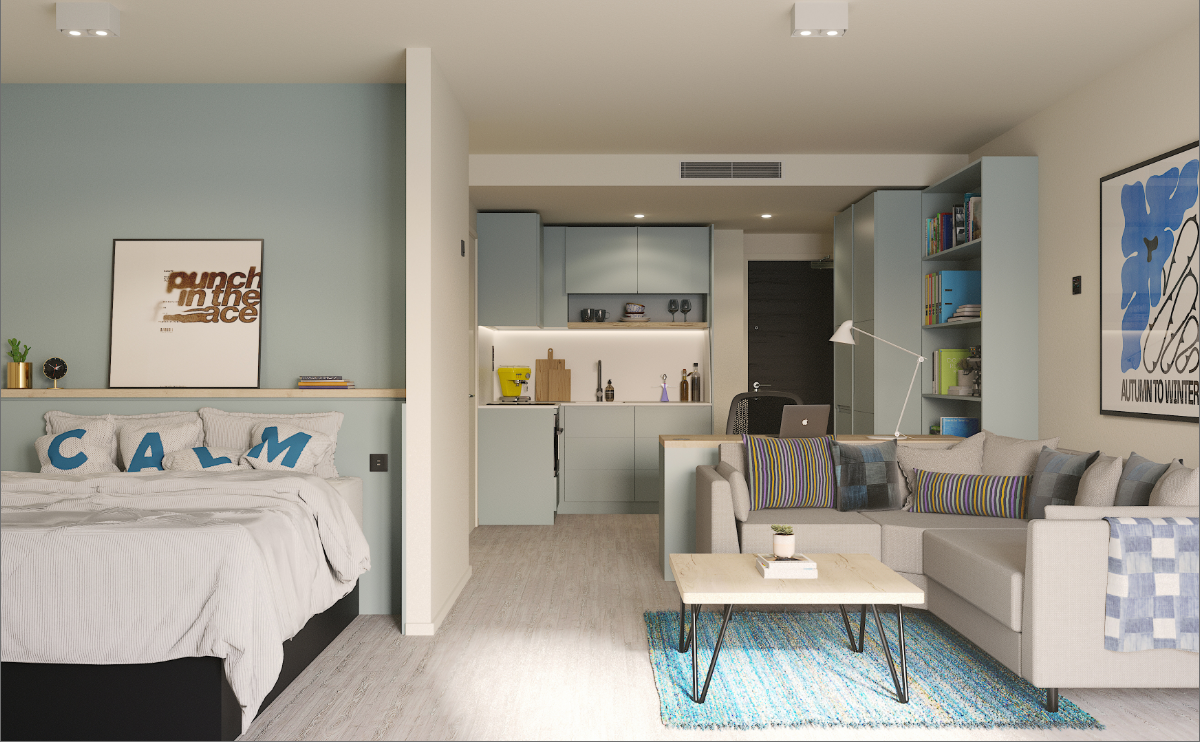 A modern studio apartment with a bed, kitchen, and living area. The bed has pillows spelling "CALM" and sits near a mint-green accent wall. The space includes a cozy sofa, a coffee table, and colorful decor.