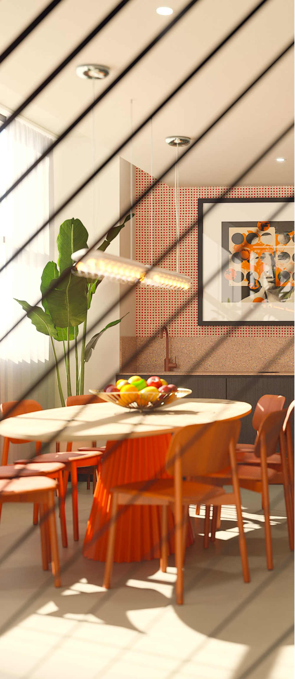 A modern dining area with orange chairs, a round table holding a fruit bowl, a large plant, and wall art. Sunlight streams in, casting diagonal shadow lines across the stylish, well-lit room.