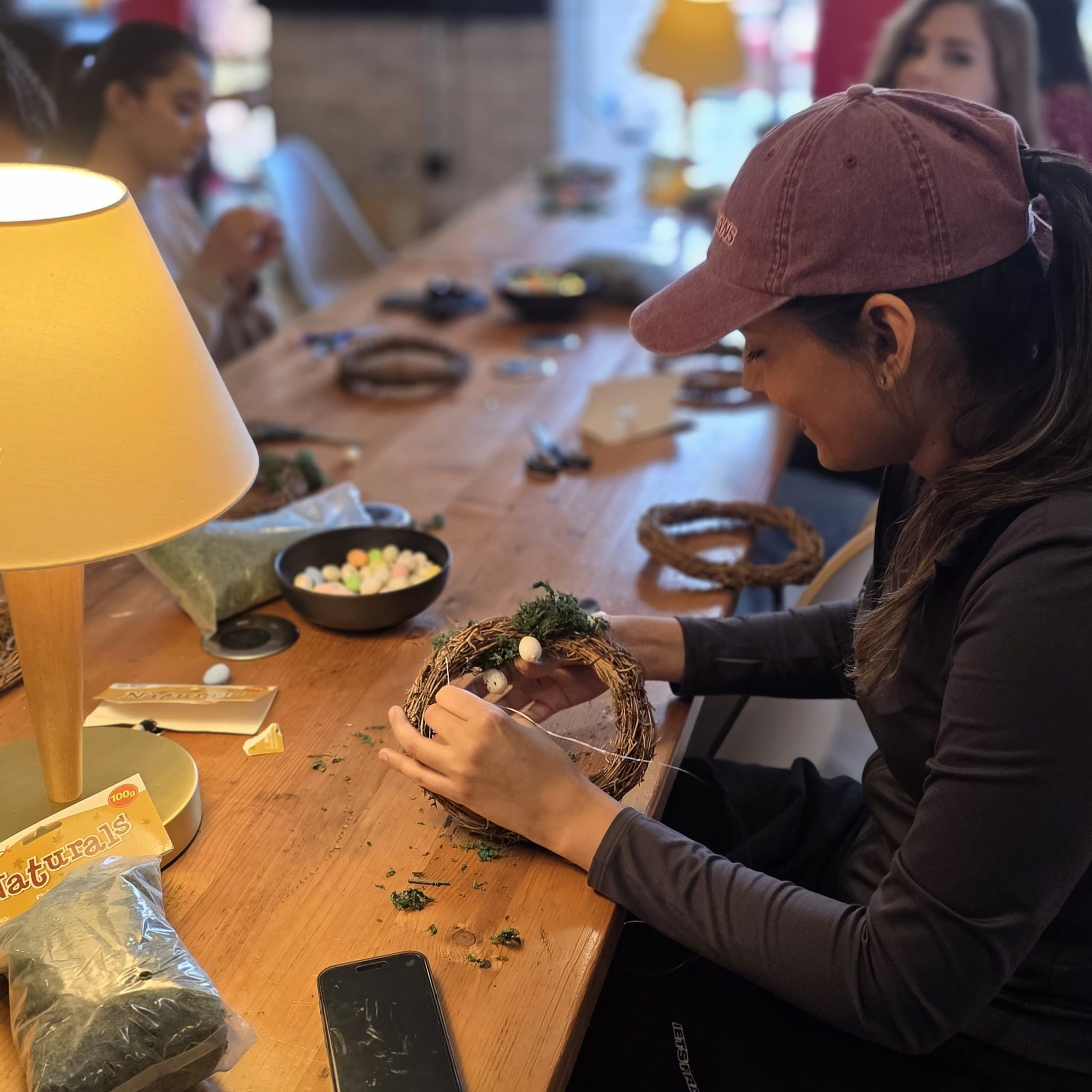 Resident crafting a wreath at a Vita Student community event