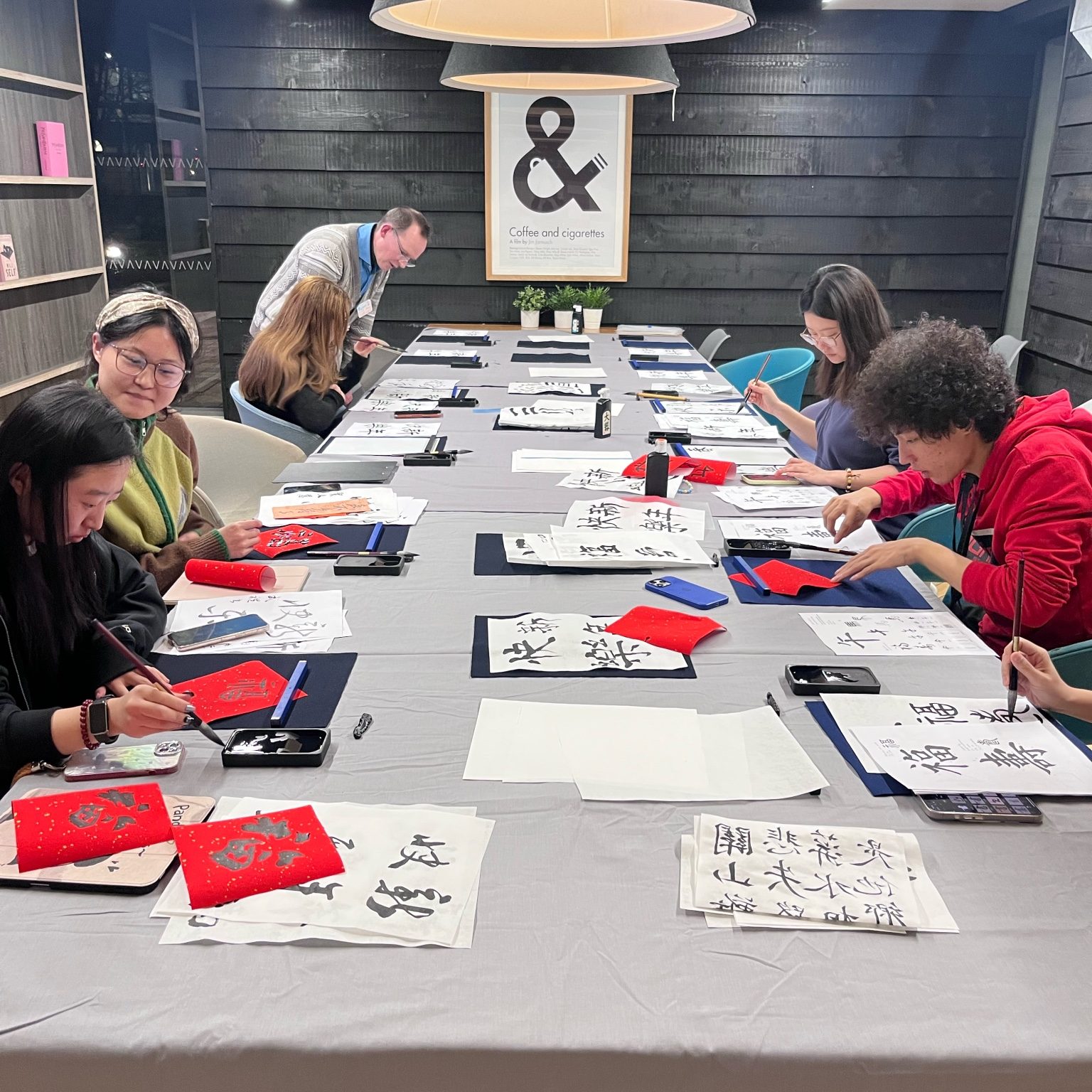 Students practicing calligraphy at a cultural event at Vita Student