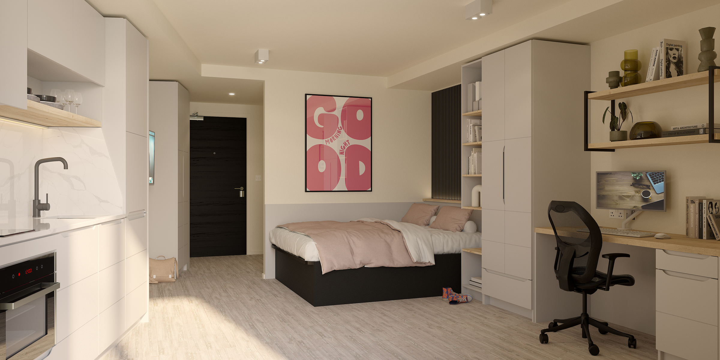 Modern studio apartment with bed, desk, shelving, and kitchenette. Soft lighting, neutral tones, and a large pink “GOOD” poster above the bed create a cozy, organized space on India Street.